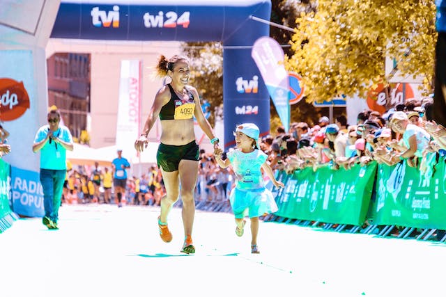 Runner and her child running the marathon together